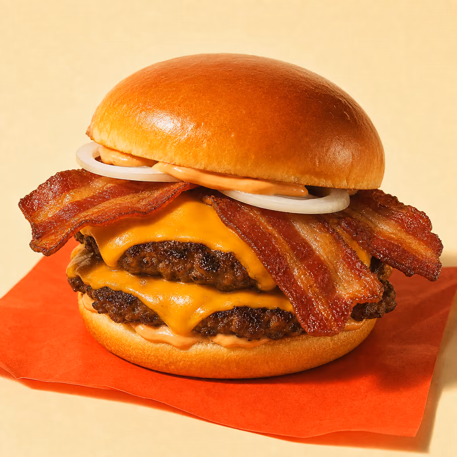 Bacon-Cheeseburger mit knusprigem Bacon, geschmolzenem Cheddar und Zwiebeln auf Doppel-Patty im getoasteten Brioche-Bun